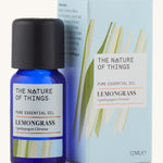 Lemongrass pure essential oil in a blue glass bottle in front of a decorative blue cardboard box.
