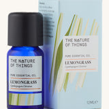 Lemongrass pure essential oil in a blue glass bottle in front of a decorative blue cardboard box.
