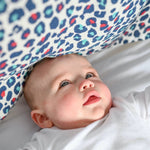 A baby looking up at the Etta Loves Extra Large Organic Cotton Baby Muslin Square - Blue Leopard