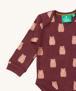A close up of the brown bear Little Green Radicals baby body suit showing the dark maroon trim and cute brown bear print on soft organic cotton fabric