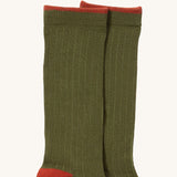 A close up of the green coloured Little Green Radicals ankle sock. Showing the soft ribbed stitch and ted trim on organic cotton fabric.