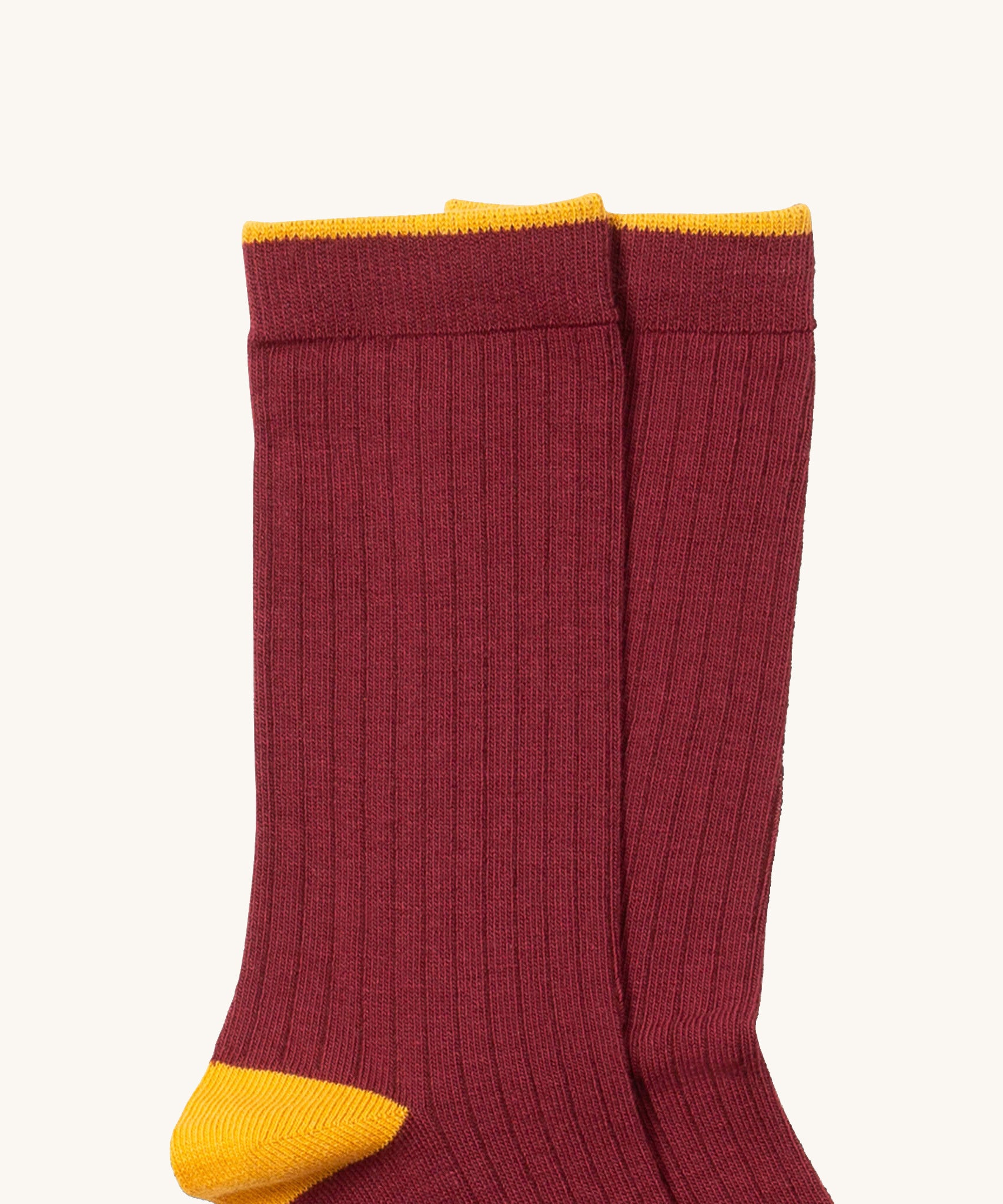 A close up of the maroon Little Green Radicals ankle sock. Showing the soft ribbed stitch and yellow trim on organic cotton fabric.