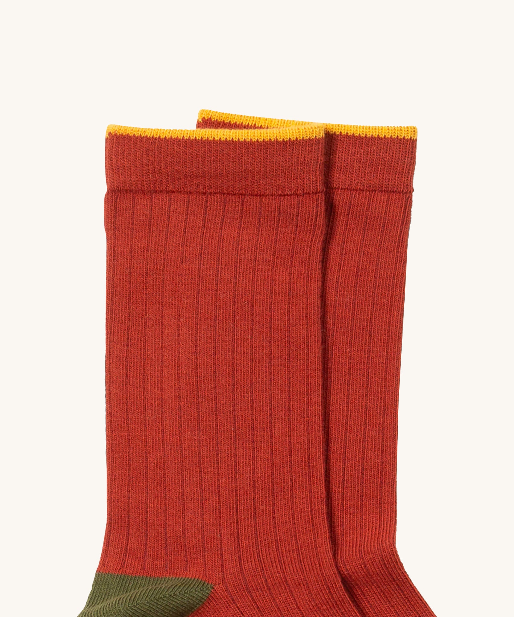A close up of the red Little Green Radicals  ankle sock. Showing the soft ribbed stitch and yellow trim on organic cotton fabric.