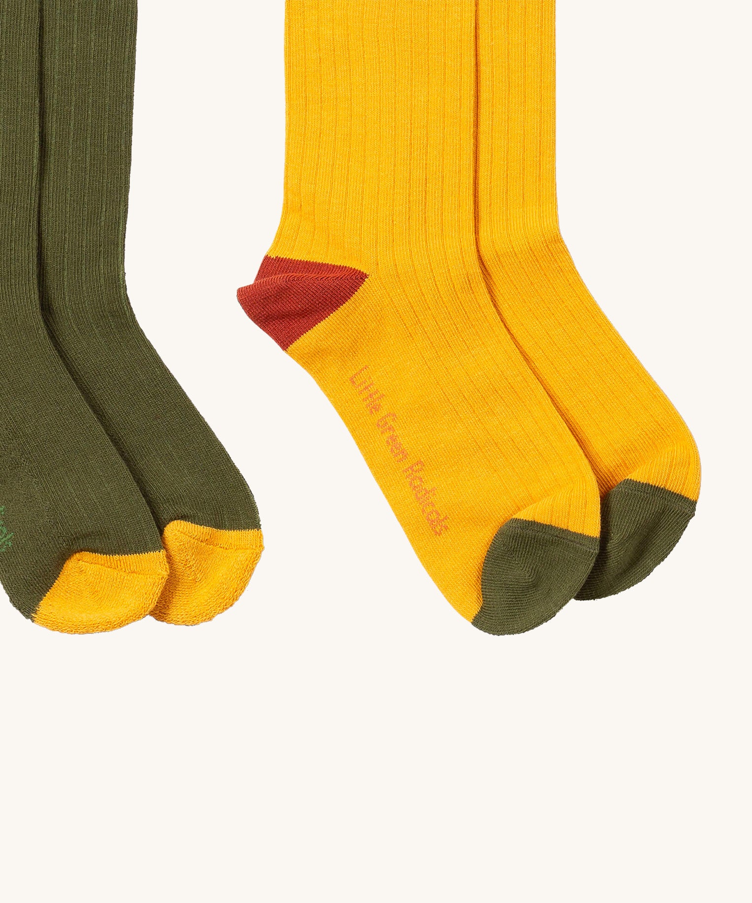 A close up of the yellow block Little Green Radicals ankle socks showing the red and green toe trim detail on soft ribbed organic cotton fabric