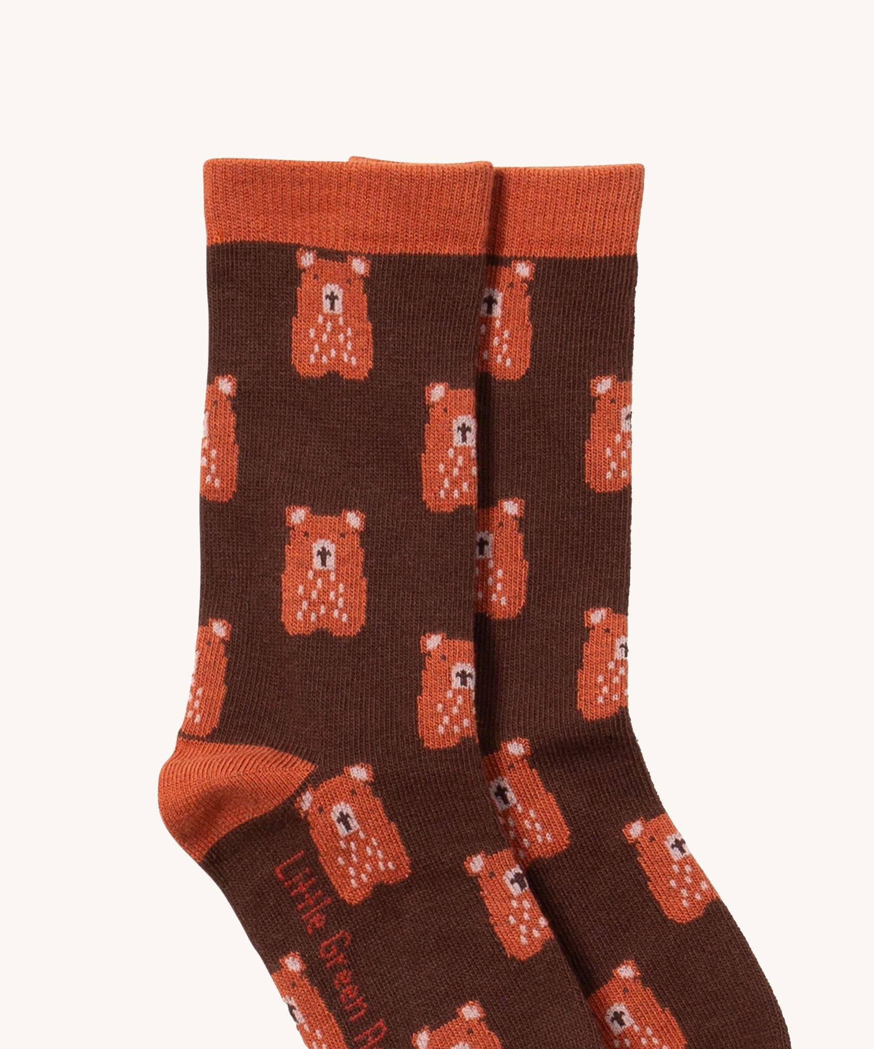 A close up of the teddy bear Little Green Radicals ankle socks showing teddy bear design with light brown ankle and heel trim on soft organic cotton fabric