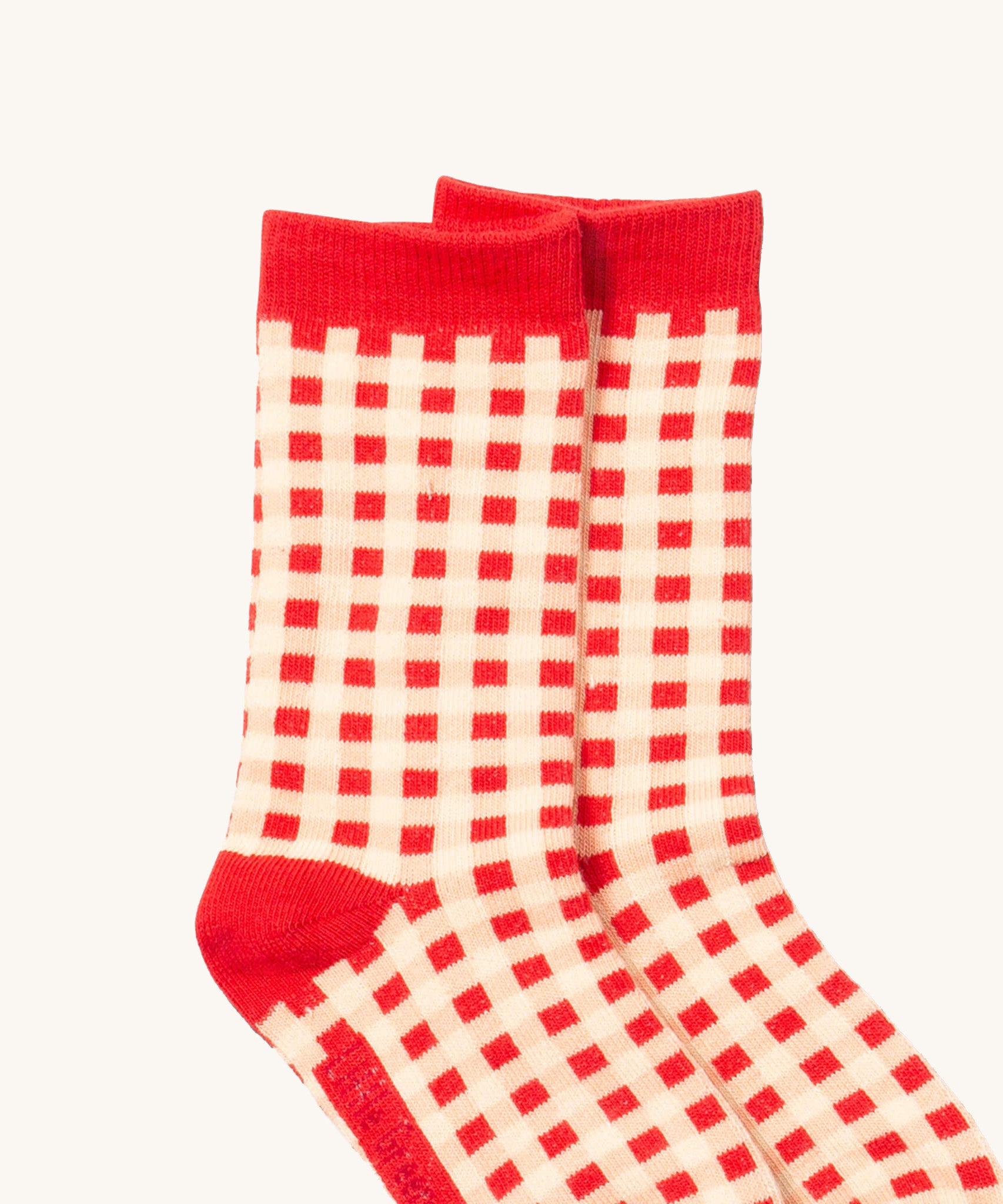 A close up of the red and white check Little Green Radicals ankle socks from the winter rabbit set showing check design with red trim detail and on soft organic cotton fabric