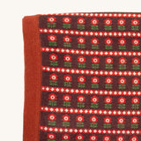 A close up of the Little Green Radicals baby blanket in collecting birds. Showing the design detail and brown textured trim on organic cotton fabric.