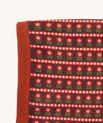 A close up of the Little Green Radicals baby blanket in collecting birds. Showing the design detail and brown textured trim on organic cotton fabric.
