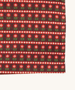 A close up of the Little Green Radicals baby blanket in collecting birds. Showing the design detail on brown organic cotton fabric.