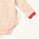 A close up of the puddle ducks Little Green Radicals baby body suit on top of the grey and cream striped bodysuit showing yellow popper detail around the crotch and leg hole detail on soft organic cotton fabric