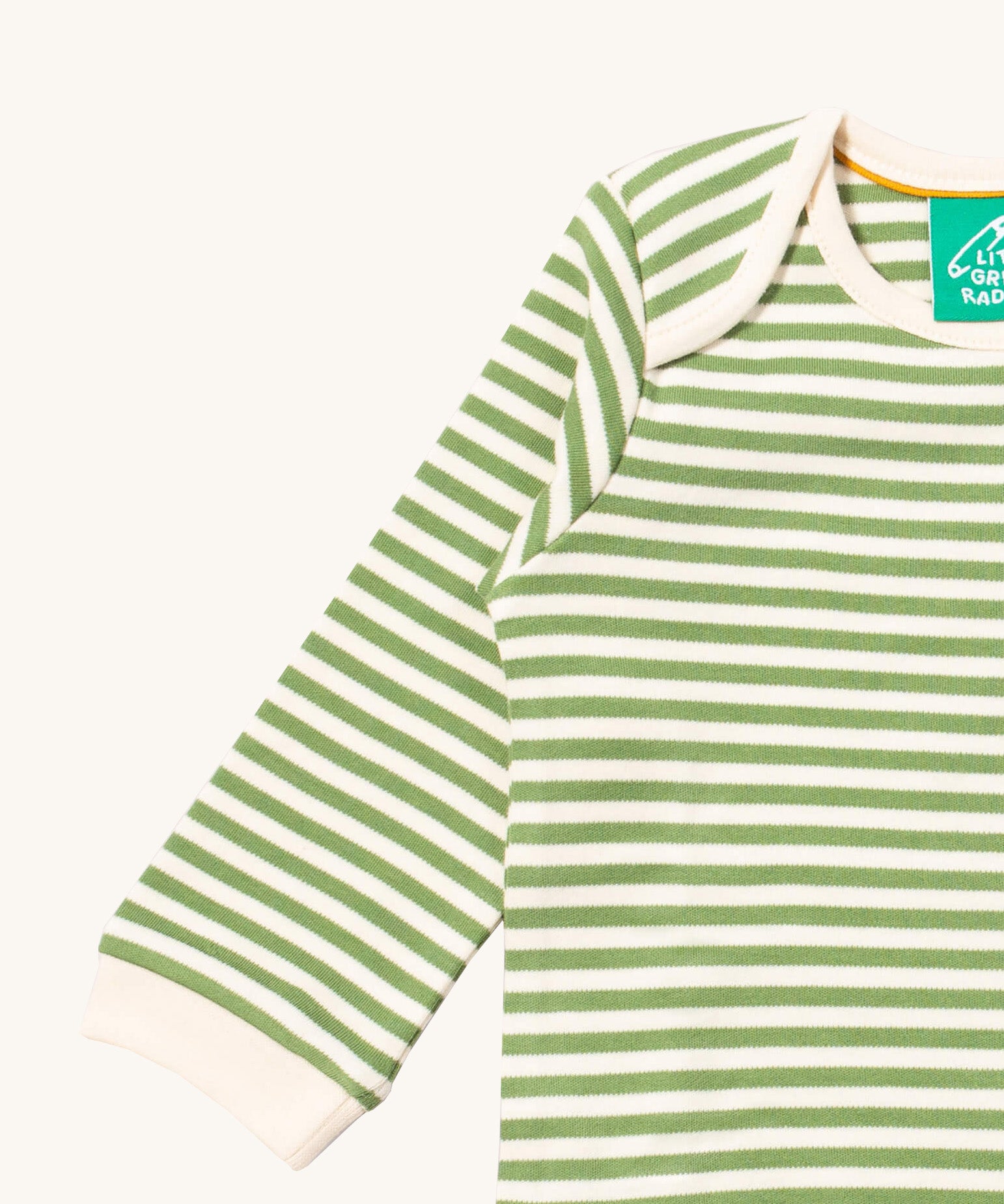 A close up of the striped Little Green Radicals baby body suit showing the light cream trim and the green and cream stripe detail on soft organic cotton fabric