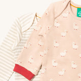 A close up of the duck Little Green Radicals baby body suit on top of the striped bodysuit showing red cuff trim and print detail on soft organic cotton fabric