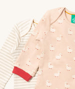 A close up of the duck Little Green Radicals baby body suit on top of the striped bodysuit showing red cuff trim and print detail on soft organic cotton fabric