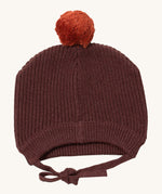 Little Green Radicals chocolate knitted beanie hat available at Babipur. A brown knitted GOTS organic cotton beanie style hat with a light brown pom pom on top. Features matching brown ties for a secure fit.