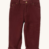 Little Green Radicals adventure jeans in chocolate corduroy available at Babipur. A soft GOTS organic cotton trousers in dark maroon with a check  design inner. It has a button fastener for a comfortable fit and 2 side pockets