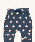 A close up of the Little Green Radicals comfy joggers in sleeping sheep showing the pocket, drawstring and kneepatch detail on navy organic cotton fabric