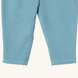 A close up of the Little Green Radicals comfy trousers in pale blue corduroy. Showing the corduroy detail on pastel blue organic cotton fabric
