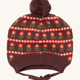 Little Green Radicals flower collecting knitted beanie hat available at Babipur. A dark brown knitted GOTS organic cotton beanie style hat with retro red flowers and matching brown pom pom on top. Features ties for a secure fit.