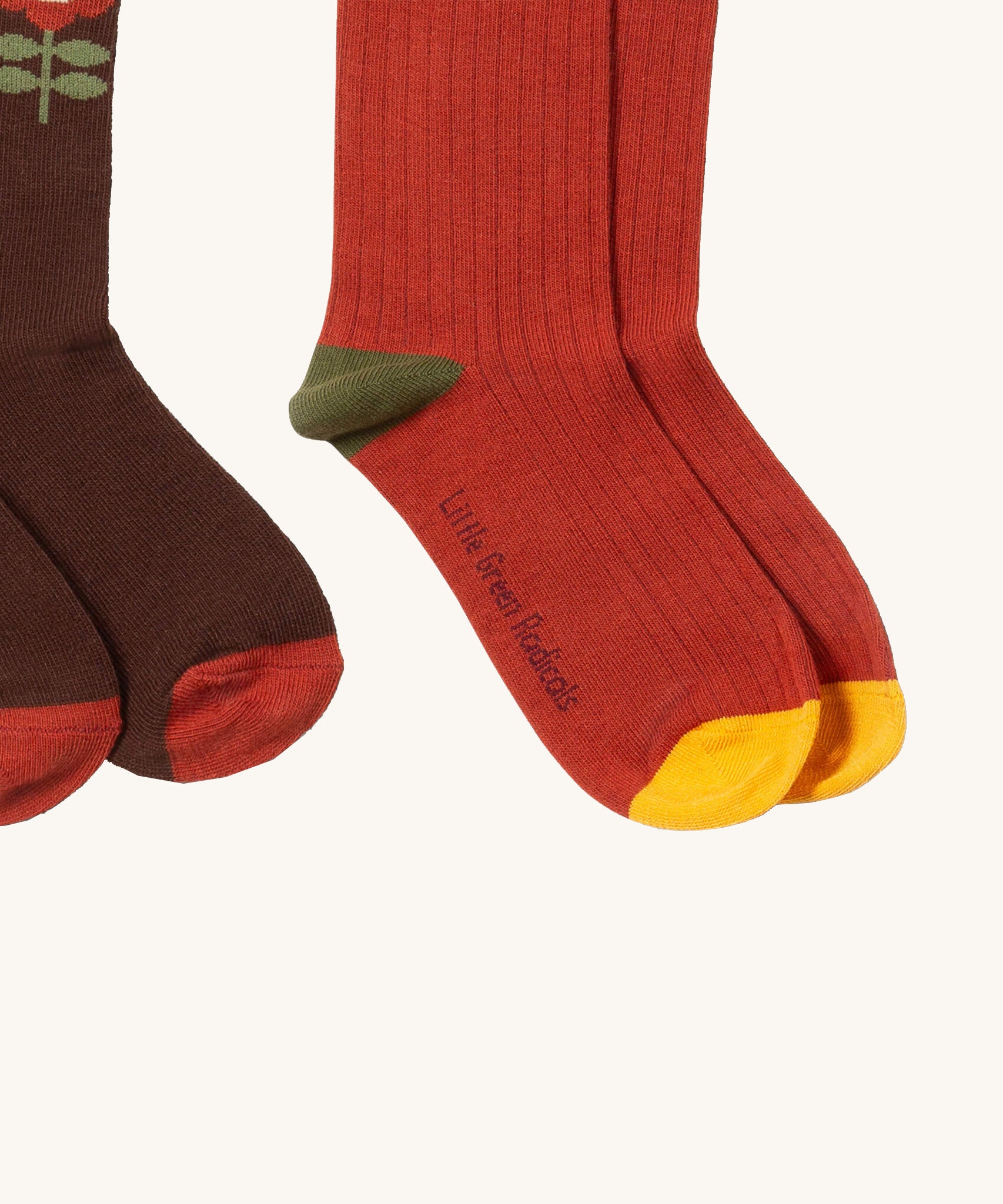 A close up of the red and flowers Little Green Radicals  ankle socks. Showing the soft ribbed stitch detail on organic cotton fabric