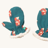 A close of the Little Green Radicals sherpa fleece mittens in foxes. Showing a close up of the fox print and white sherpa fleece detail on turquoise organic cotton fabric.