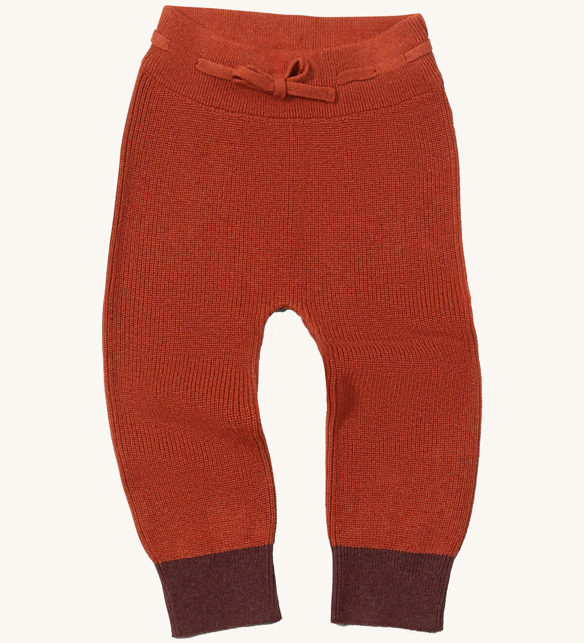 Little Green Radicals ginger knitted leggings available at Babipur. A soft GOTS knitted style leggings in dark orange with contrast trim. Features an elasticated band with drawstring. 