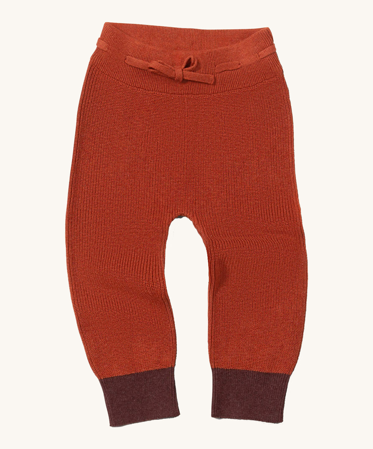 Little Green Radicals ginger knitted leggings available at Babipur. A soft GOTS knitted style leggings in dark orange with contrast trim. Features an elasticated band with drawstring. 