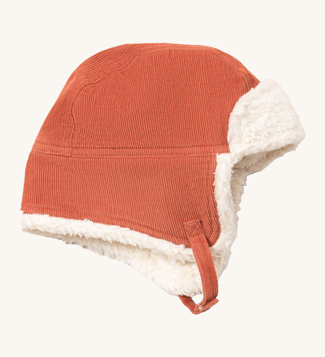 Little Green Radials sherpa fleece cosy hat in ginger available at Babipur. A GOTS organic cotton ginger hat in a corduroy style with turn up ear flaps and a white sherpa style fleece inner. Features a chin strap with popper fastener for a secure fit