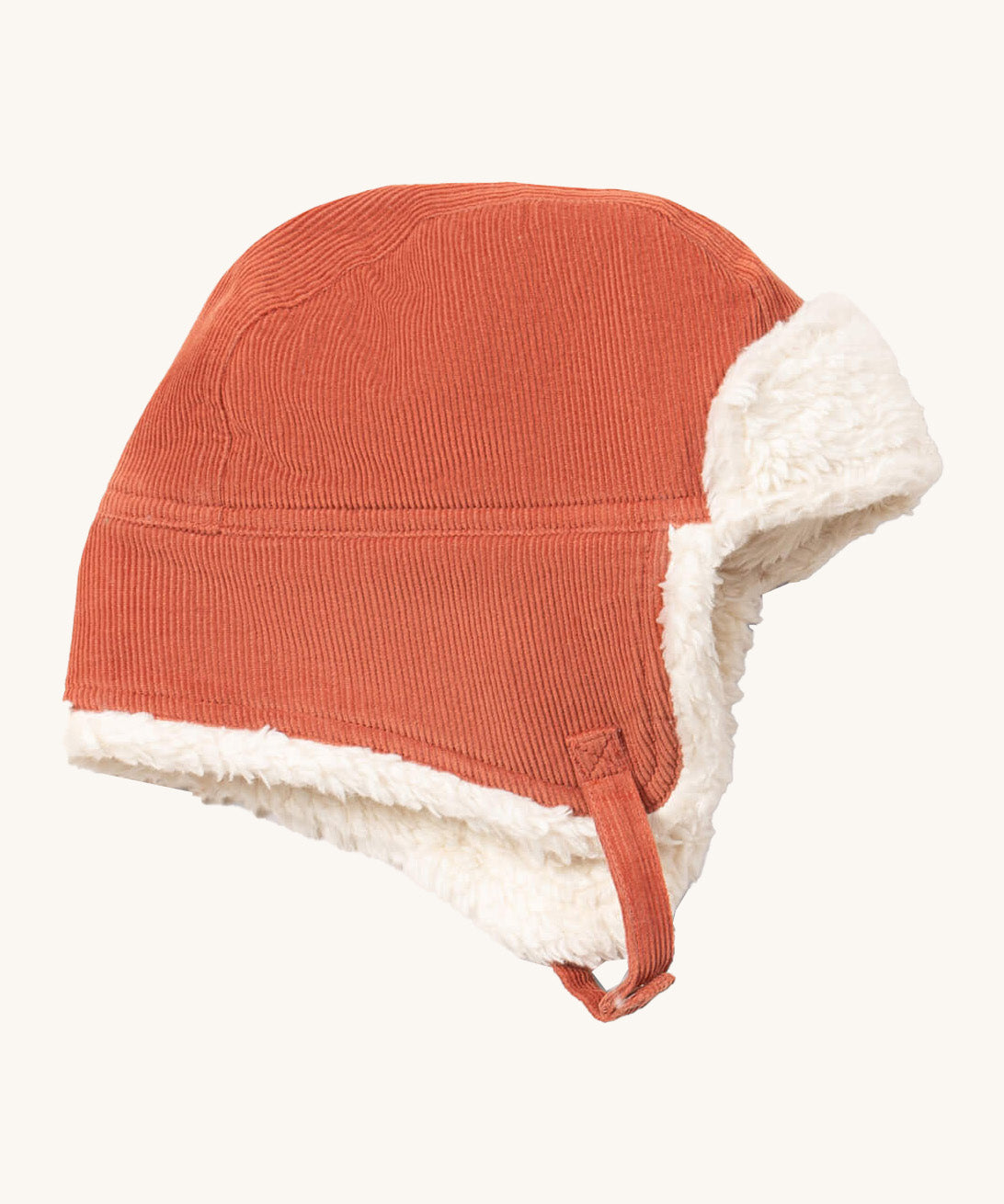 Little Green Radials sherpa fleece cosy hat in ginger available at Babipur. A GOTS organic cotton ginger hat in a corduroy style with turn up ear flaps and a white sherpa style fleece inner. Features a chin strap with popper fastener for a secure fit