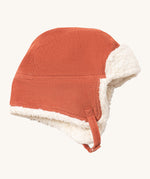 Little Green Radials sherpa fleece cosy hat in ginger available at Babipur. A GOTS organic cotton ginger hat in a corduroy style with turn up ear flaps and a white sherpa style fleece inner. Features a chin strap with popper fastener for a secure fit
