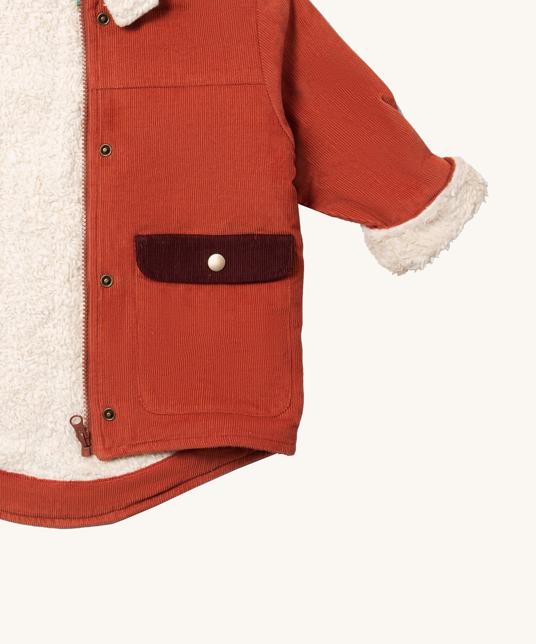 A close up of the Little Green Radicals gingert sherpa toasty coat available at  Babipur. Showing the white sherpa fleece inner liner full length zip detail and a close up of the side pocket