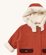 A close up of the Little Green Radicals ginger sherpa toasty coat available at Babipur. Showing the white sherpa style fleece under the hood, the cuff for warmth and corduroy detail on GOTS organic cotton fabric. 