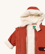 Little Green Radicals ginger sherpa toasty coat available at  Babipur. A GOTS organic cotton winter corduroy style jacket  in dark orange with a white fleece inner for warmth. Features a full length zip and popper fasteners for a secure fit.