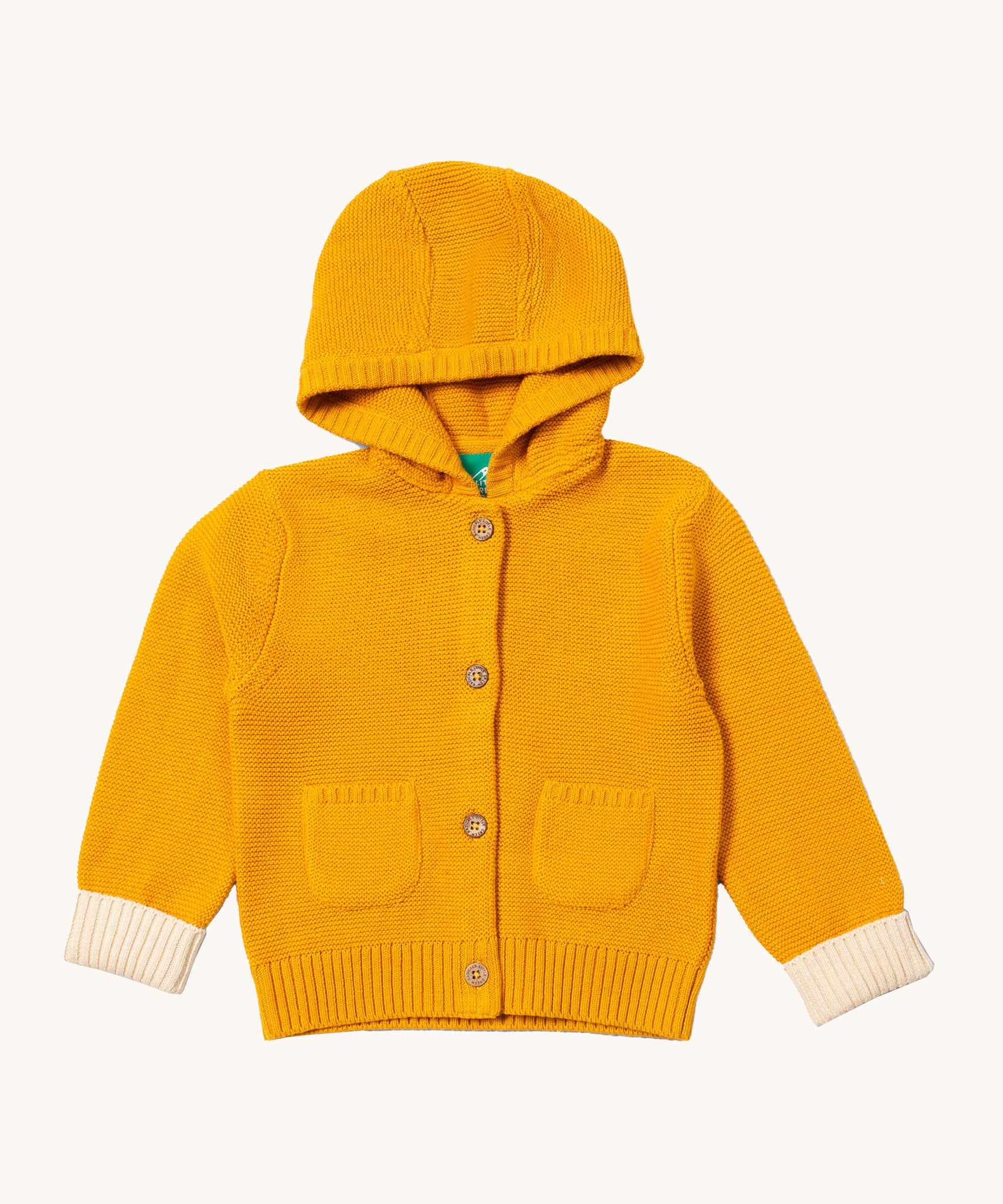 Little Green Radicals gold snuggly hooded knitted cardigan available at Babipur. A GOTS organic cotton warm cardigan in yellow with a cream cuff trim. Features a hood, 2 pouch pockets and button fasteners down the middle