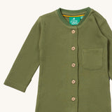 A close up of the Little Green Radicals green chive waffle playsuit showing the button fastener detail and waffle knit detail. 