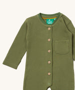 A close up of the Little Green Radicals green chive waffle playsuit showing the button fastener detail and waffle knit detail. 