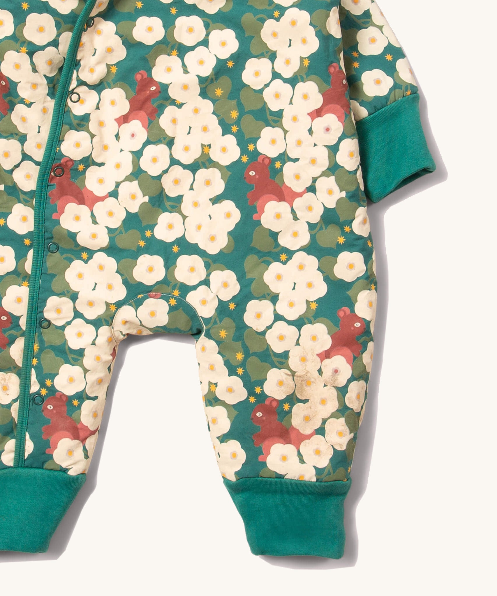 A close up of the Little Green Radicals sherpa line snow suit in hedgerow. Showing the teal trim detail and a close up of the squirrel print on GOTS organic cotton fabric
