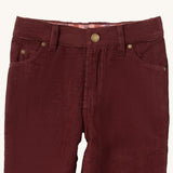 A close up of the Little Green Radicals adventure jeans in chocolate corduroy. Showing the pocket and button clip detail on dark maroon soft GOTS organic cotton fabric