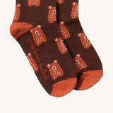 A close up of the teddy bear Little Green Radicals ankle socks showing teddy bear design with light brown trim and brand name on the sole on soft organic cotton fabric