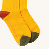 Little Green Radicals yellow block ankle socks from the winter rabbit set available at Babipur. A GOTS organic cotton sock with green and red trim with the brand name on the sole
