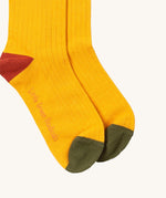 Little Green Radicals yellow block ankle socks from the winter rabbit set available at Babipur. A GOTS organic cotton sock with green and red trim with the brand name on the sole