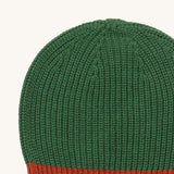 A close up of the Little Green Radicals knitted beanie in chive. Showing the thick green knit detail on organic cotton fabric.
