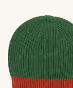A close up of the Little Green Radicals knitted beanie in chive. Showing the thick green knit detail on organic cotton fabric.