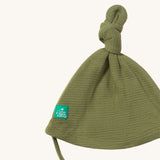 A close up of the Little Green Radicals chive waffle tie hat showing the knot detail  on green organic cotton fabric