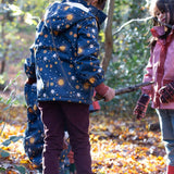A child playing in the woods and wearing the chocolate comfy trousers. A corduroy style trouser made from GOTS organic cotton fabric.