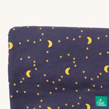 A close up of the Little Green Radicals dark night sherpa hooded blanket. Showing starry night print detail on soft navy organic cotton fabric.