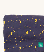 A close up of the Little Green Radicals dark night sherpa hooded blanket. Showing starry night print detail on soft navy organic cotton fabric.