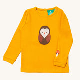 Little Green Radicals gold brown owl applique long sleeve top available at Babipur. A GOTS organic cotton top in yellow with a cute brown applique on the front and a mushroom applique on the sleeve. Features popper fasteners on the back.