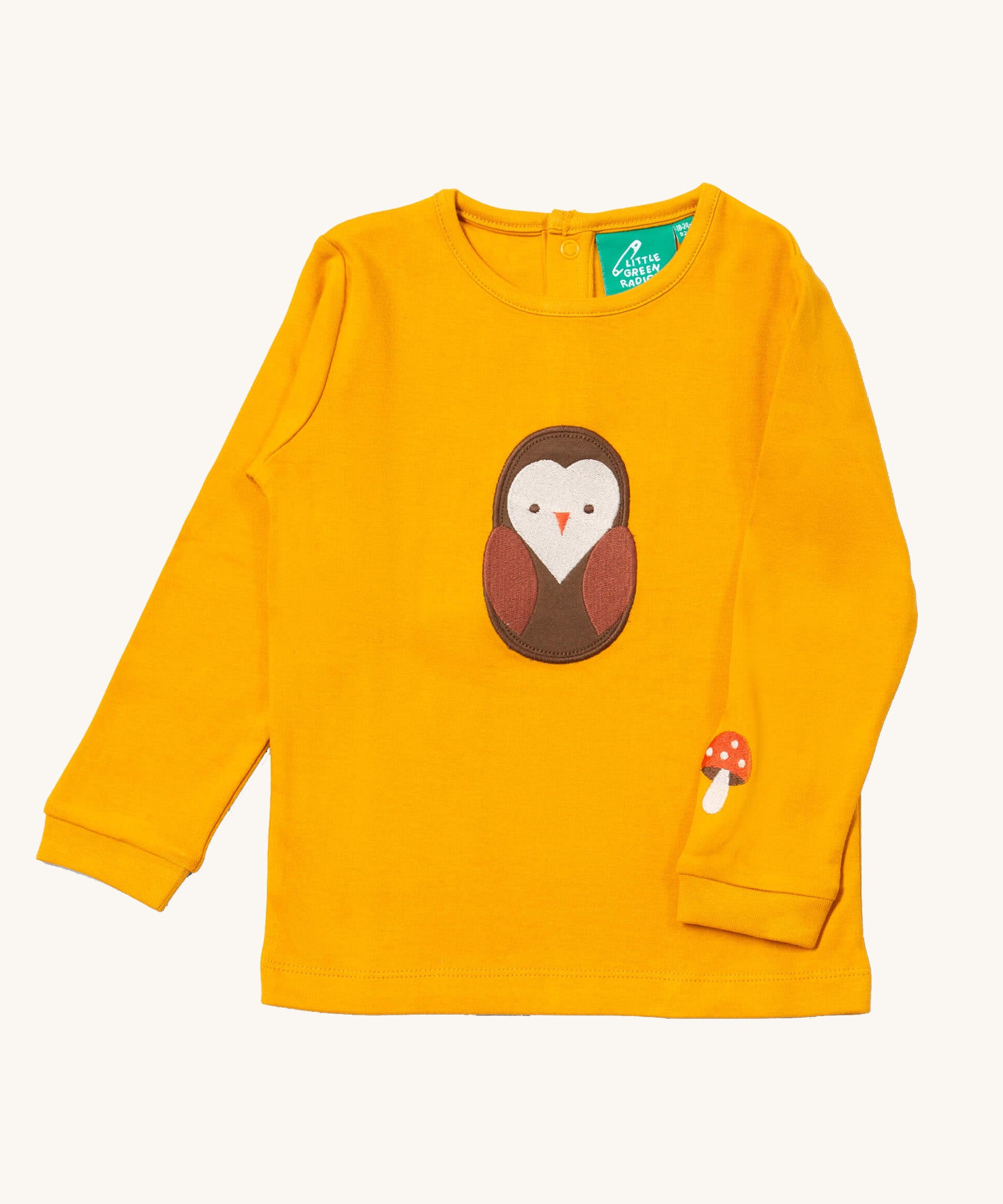 Little Green Radicals gold brown owl applique long sleeve top available at Babipur. A GOTS organic cotton top in yellow with a cute brown applique on the front and a mushroom applique on the sleeve. Features popper fasteners on the back.