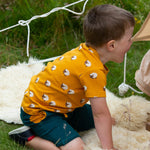  this t-shirt has a fun sheep print on orange fabric