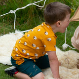  this t-shirt has a fun sheep print on orange fabric